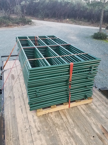 green Fence Panels strapped to pallet.